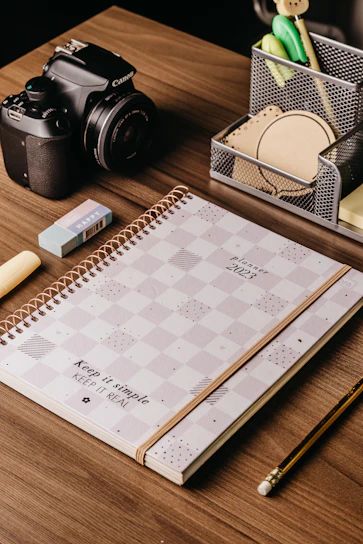 A neatly arranged office desk featuring deskmate's file organizers, pens, and binding supplies in various styles.