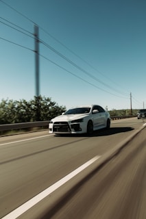 A sports car in motion on a highway.