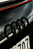 Audi rings badge displayed on a polished silver car front.