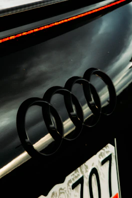 Audi rings badge displayed on a polished silver car front.