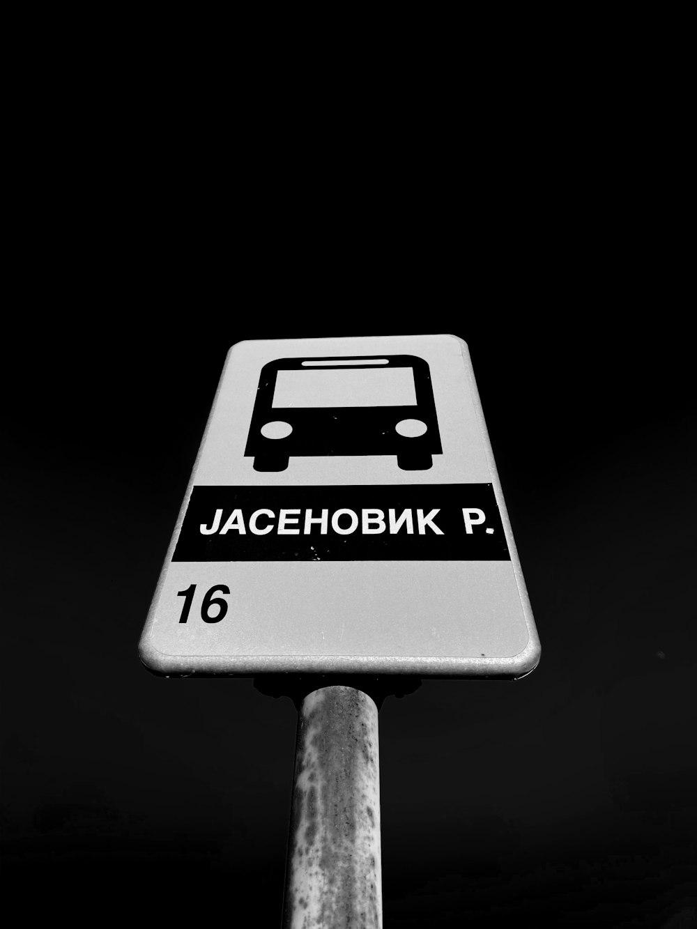 a black and white photo of a street sign