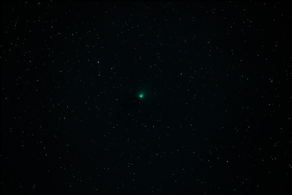 a green object is in the middle of the night sky