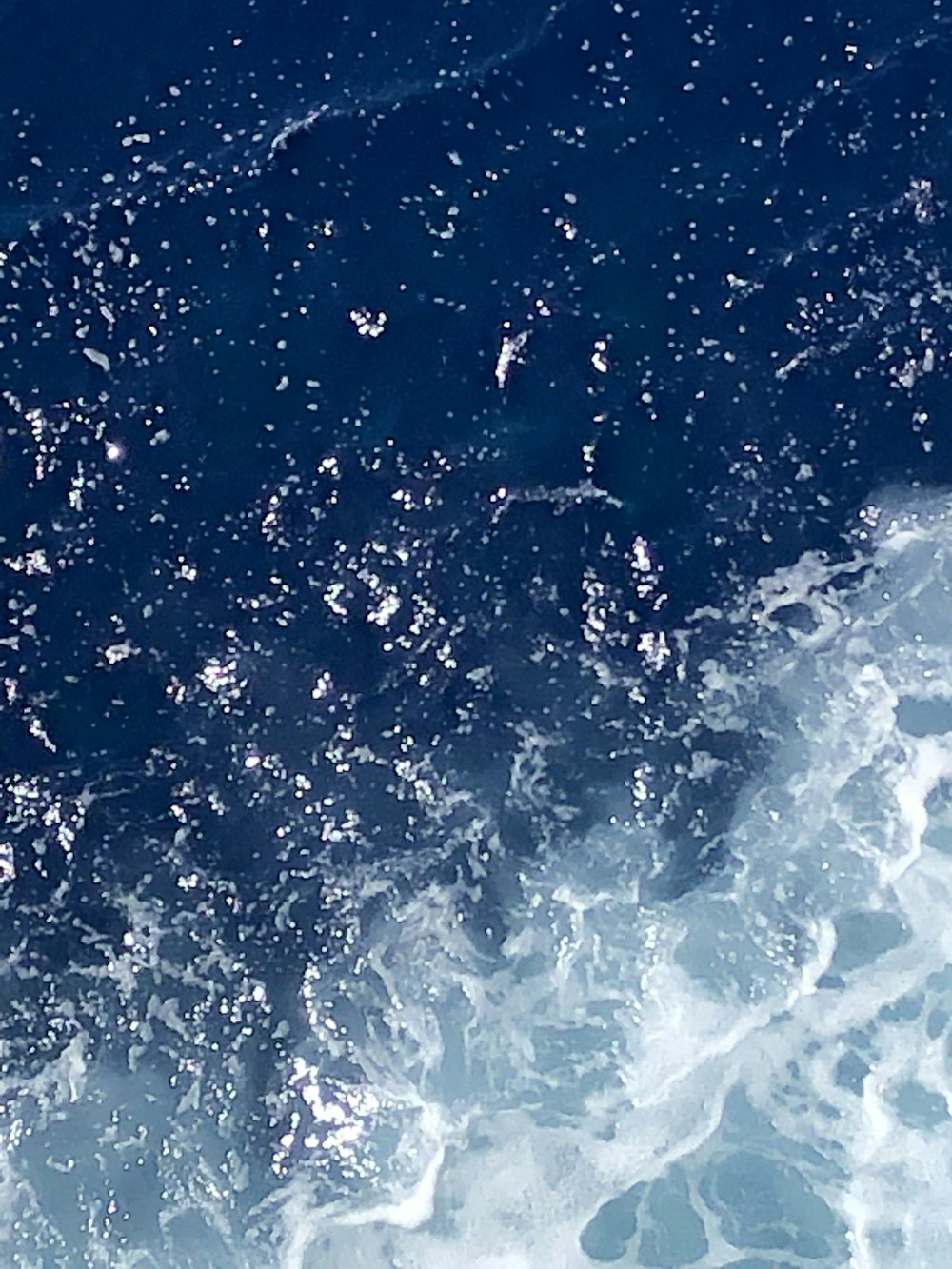 a man riding a surfboard on top of a wave in the ocean