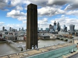 Aerial view of Canary Wharf with high-rise buildings and river Thames in the background.