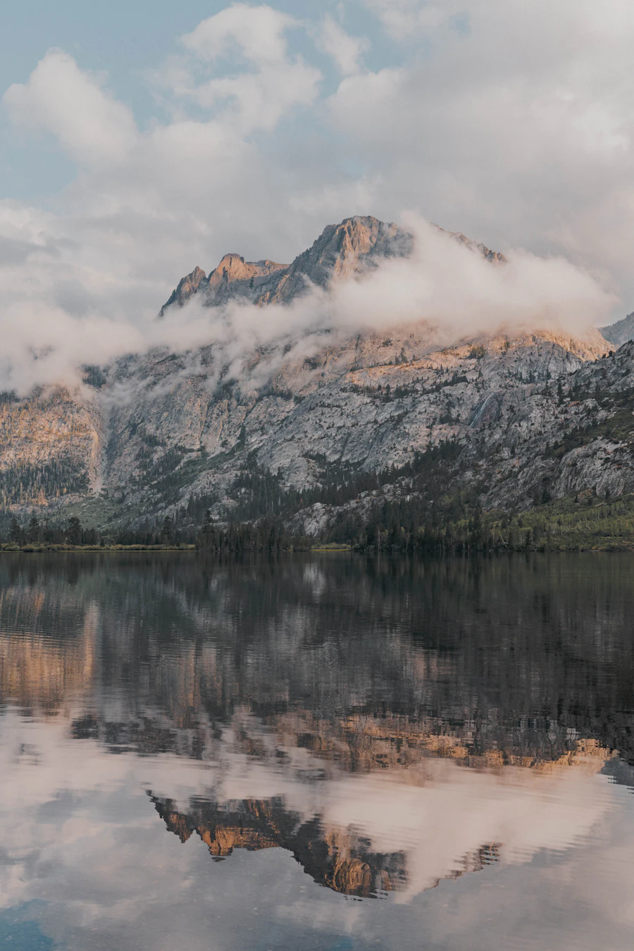 Mountains reflected in the still water of a calm lake