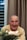 An elderly man enjoying a film with his family around him.