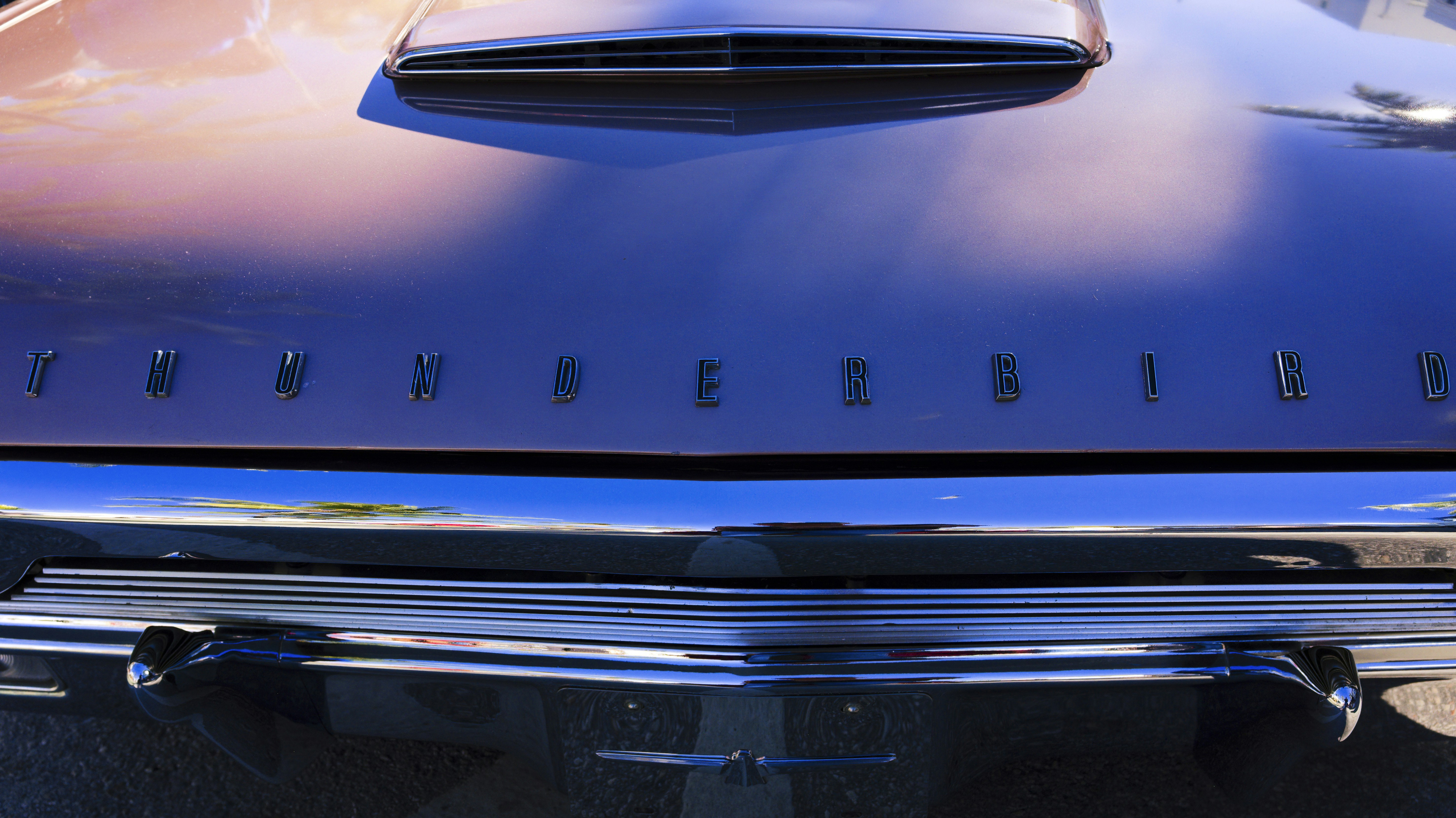 a close up of the hood of a classic car