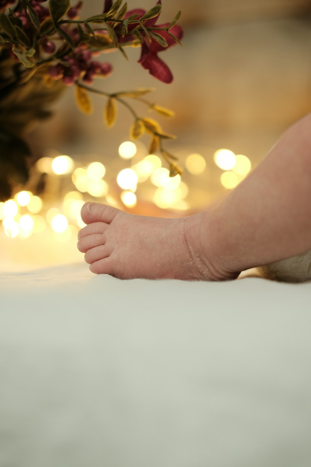 a close up of a baby's foot on a bed