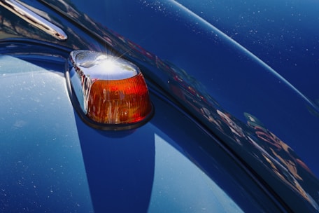 Close-up of a fresh, glossy paint finish on a restored vehicle under natural light.
