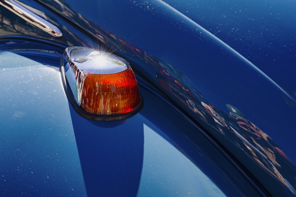 a close up of the tail light of a blue car