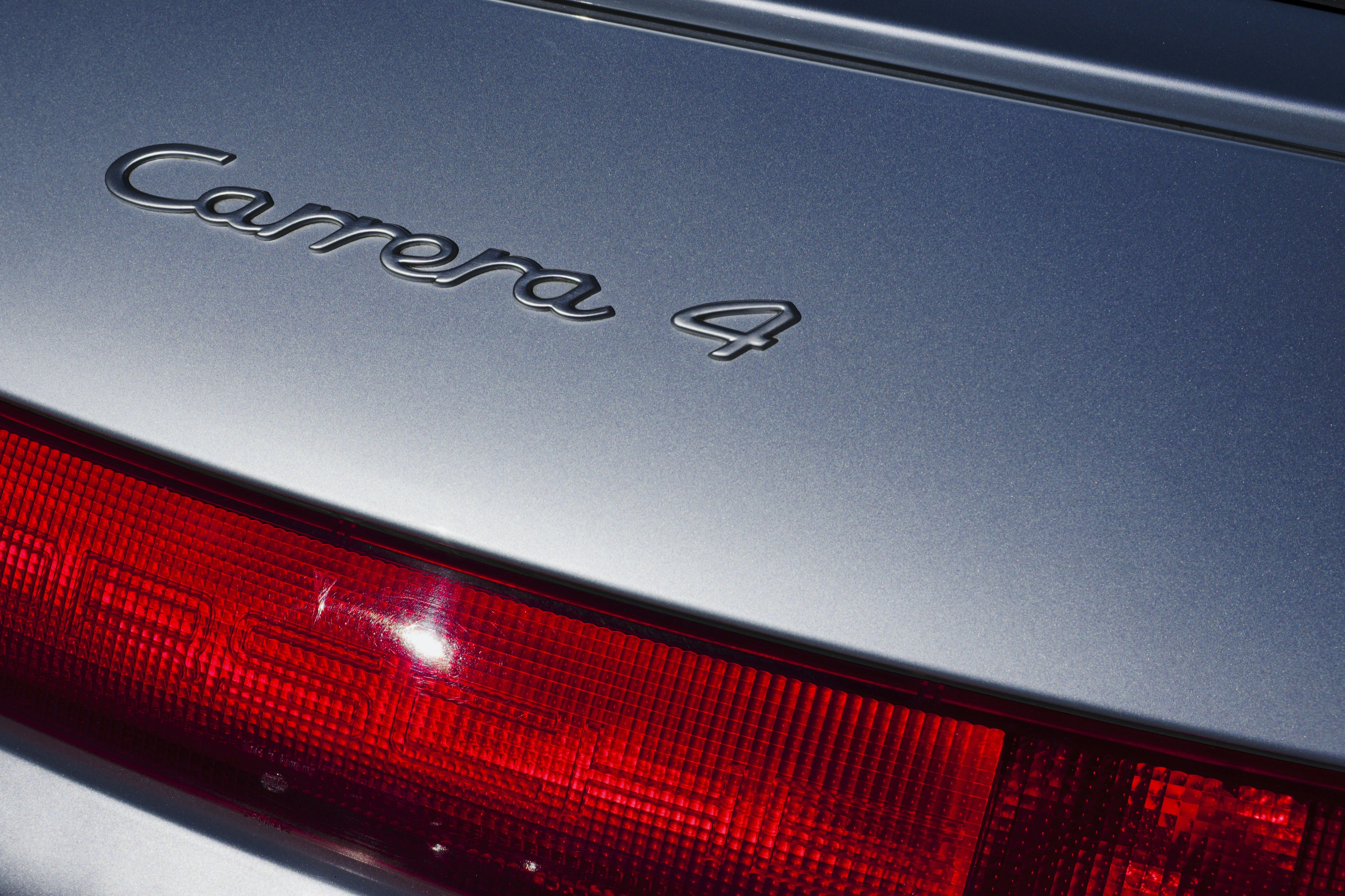 the back end of a silver car with the word canon on it