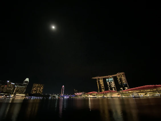 A sleek nighttime view of Manhattan's skyline featuring sharp architectural lines under a deep midnight navy sky.
