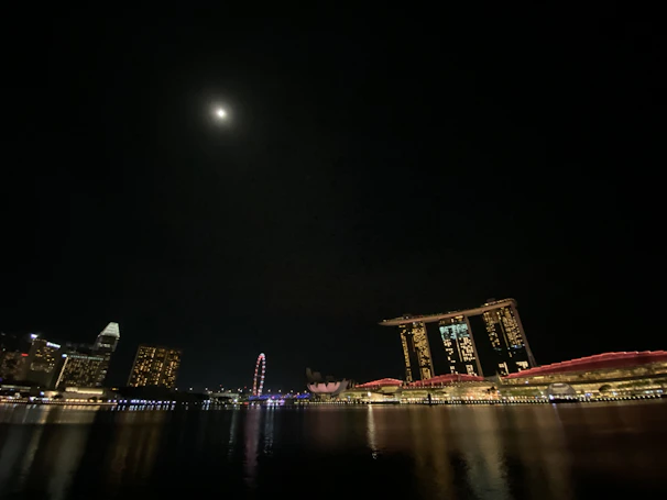 A sleek, nighttime Manhattan skyline highlighting iconic architectural landmarks under a deep midnight navy sky.