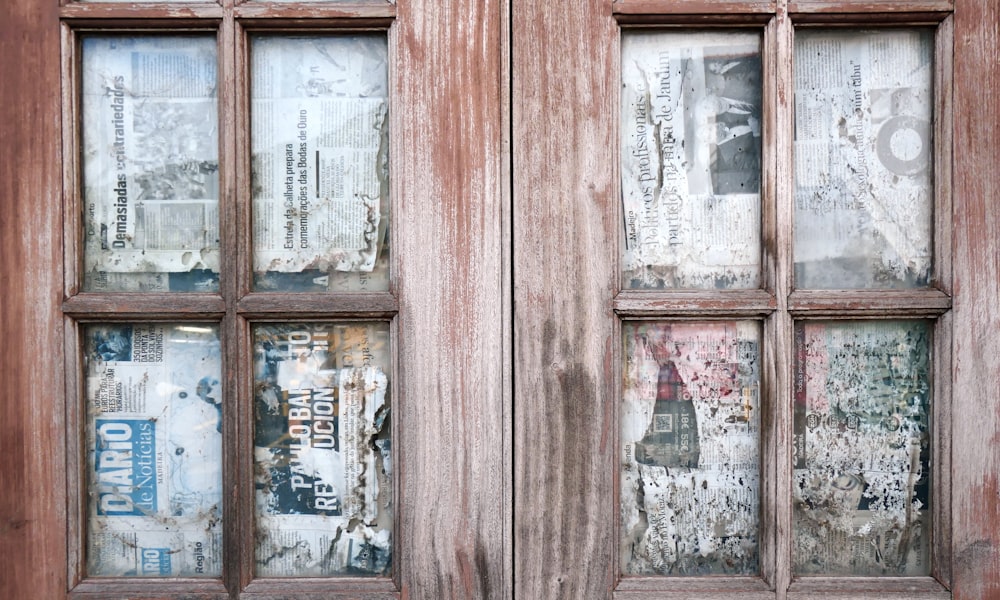 a window with a bunch of newspaper on it