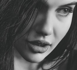 A candid shot of a confident woman with alluring eyes, ready for a private chat.