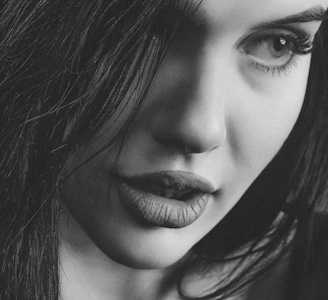 A close-up of a woman’s smile, lips slightly parted, evoking mystery and allure.
