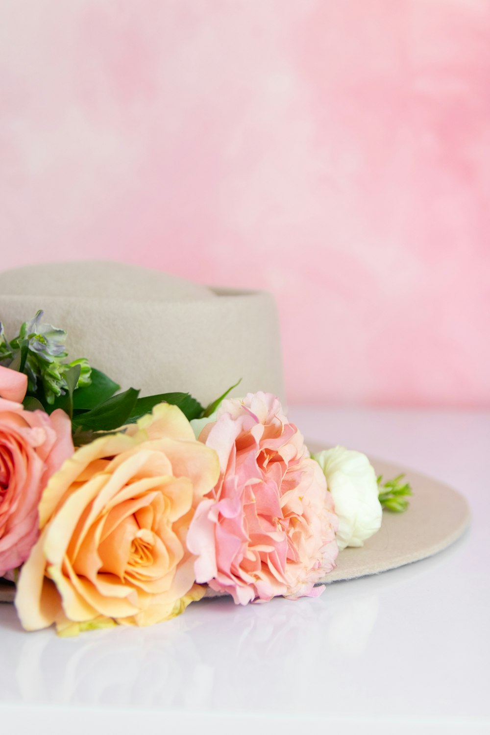 a hat with flowers on it sitting on a table