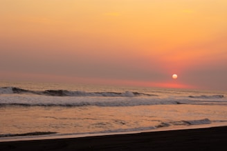 A serene, smooth painting of a sunset blending warm tones that flow softly into a deep blue sky.