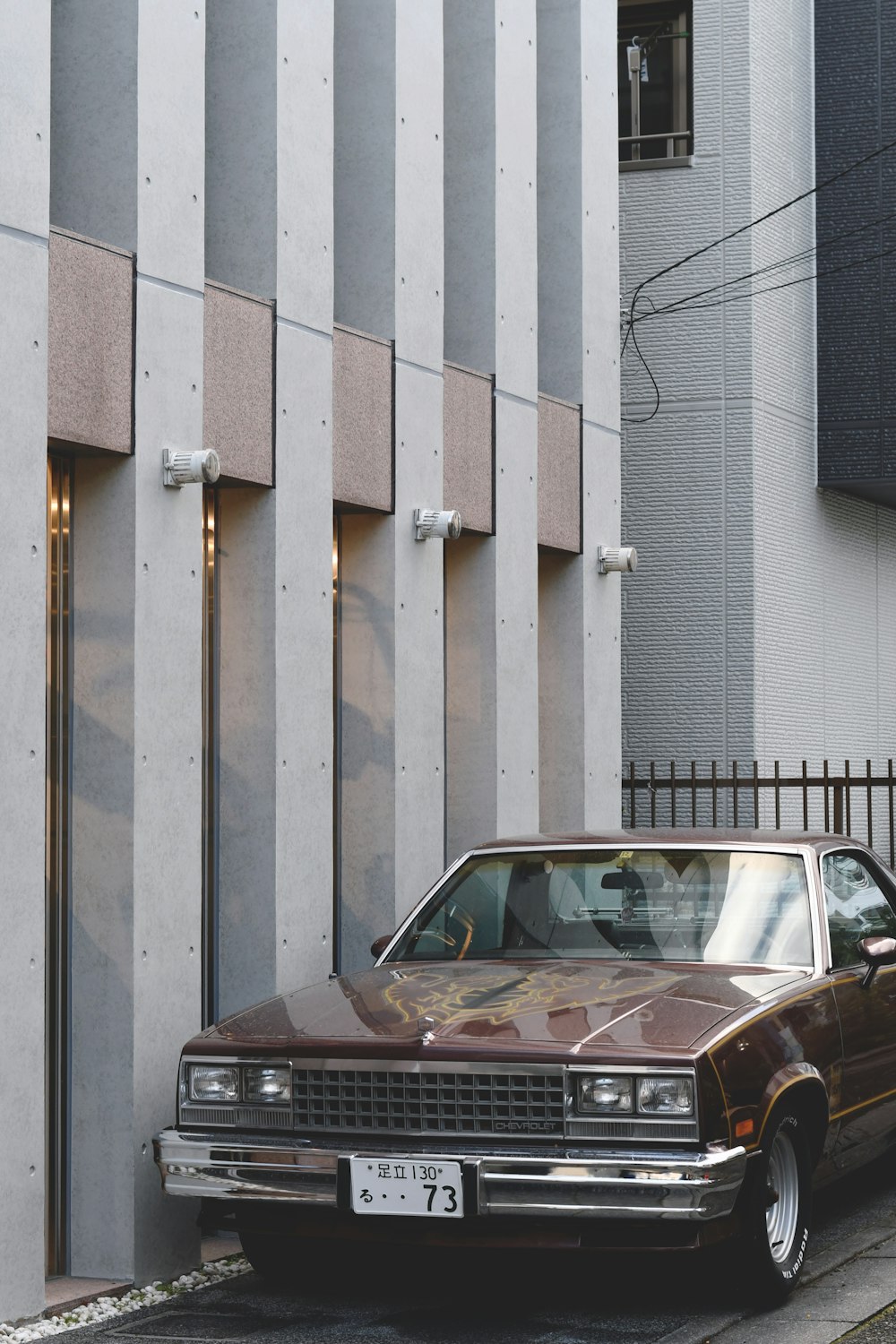 a brown car parked on the side of a street