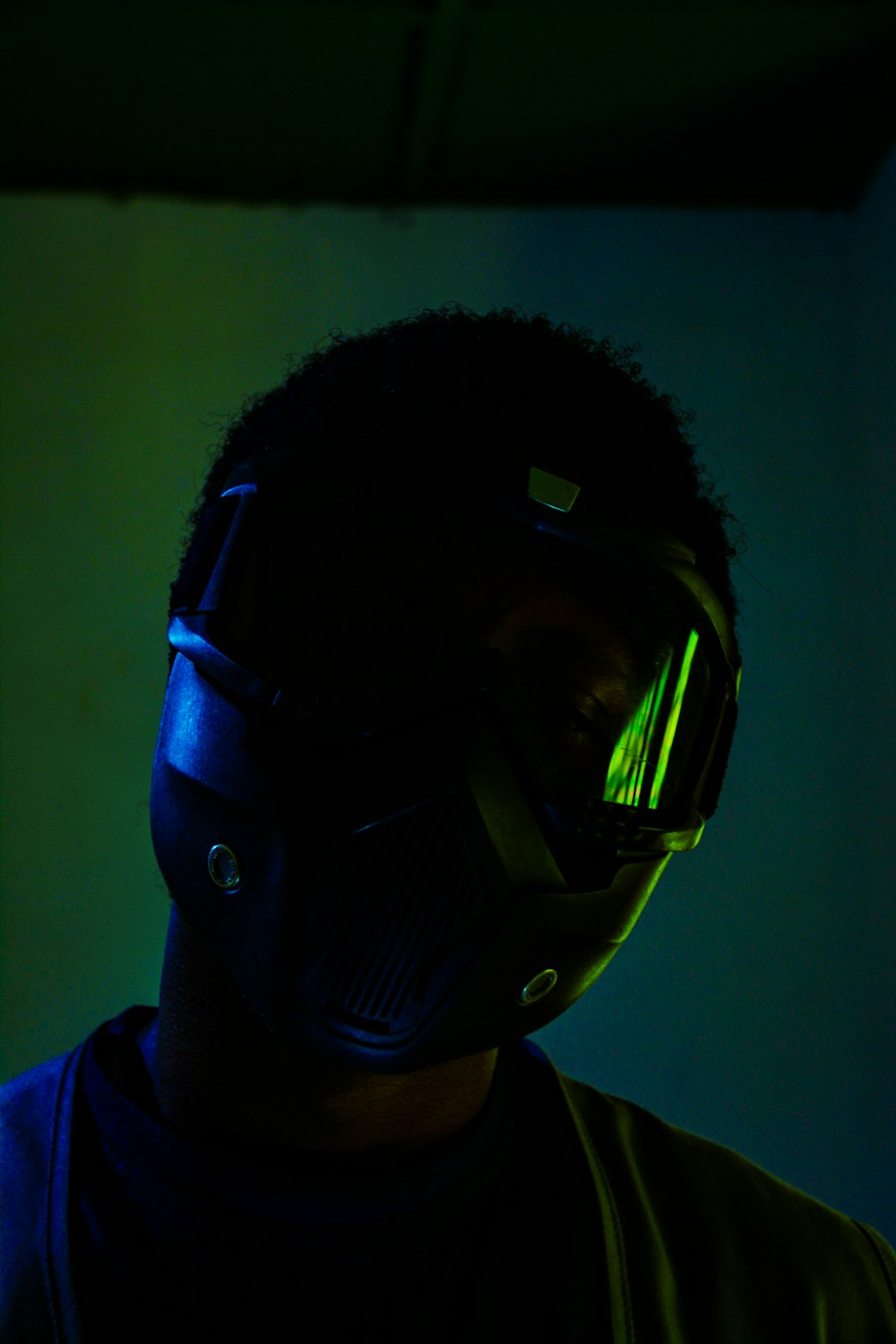 a man in a dark room wearing a helmet and goggles