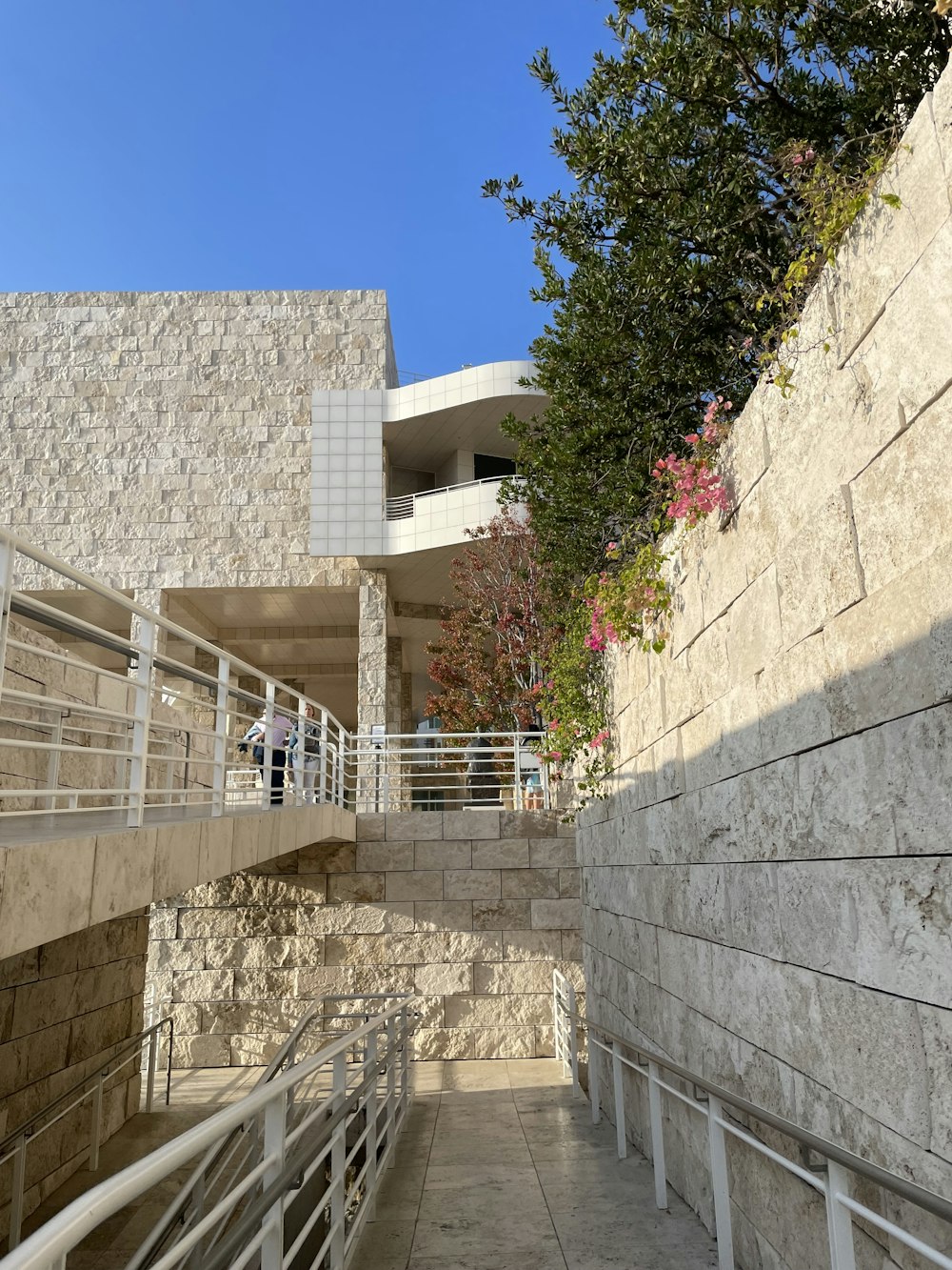 a stone building with a white railing next to it