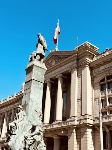 a large building with a statue on top of it