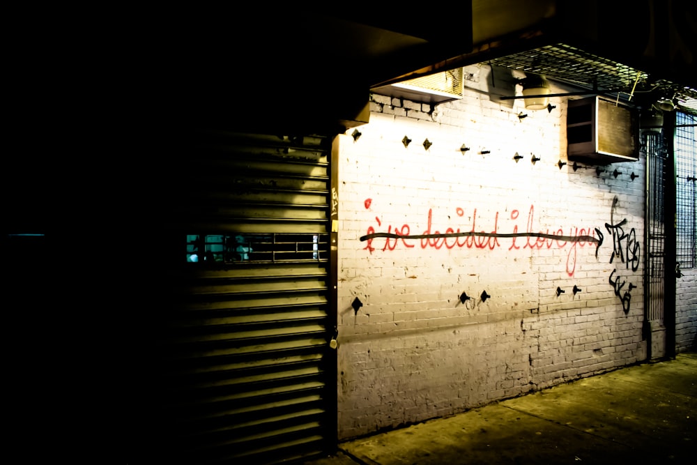 a white brick wall with graffiti on it