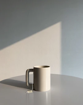 a white mug sitting on top of a table
