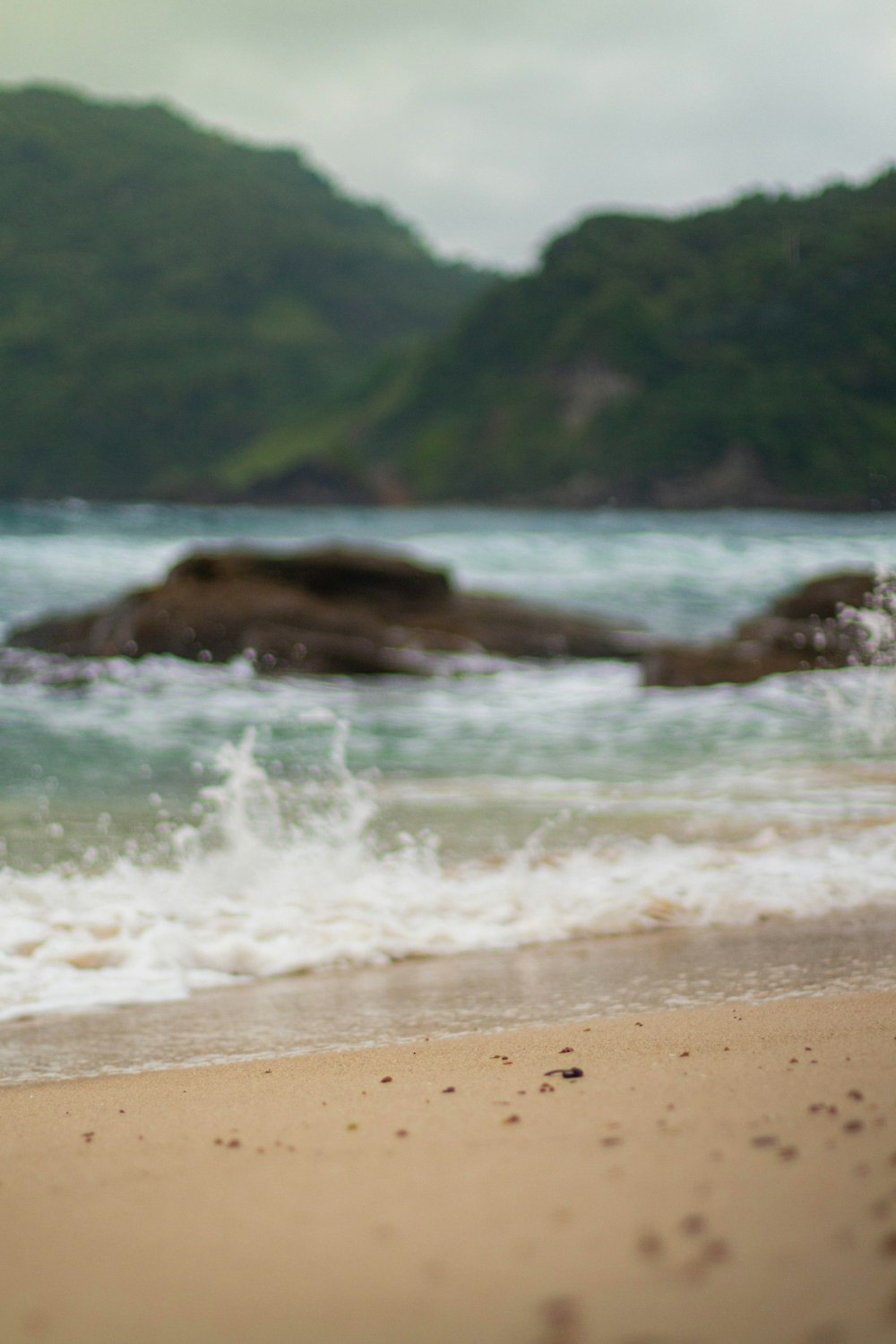 a surfboard sitting on top of a sandy beach