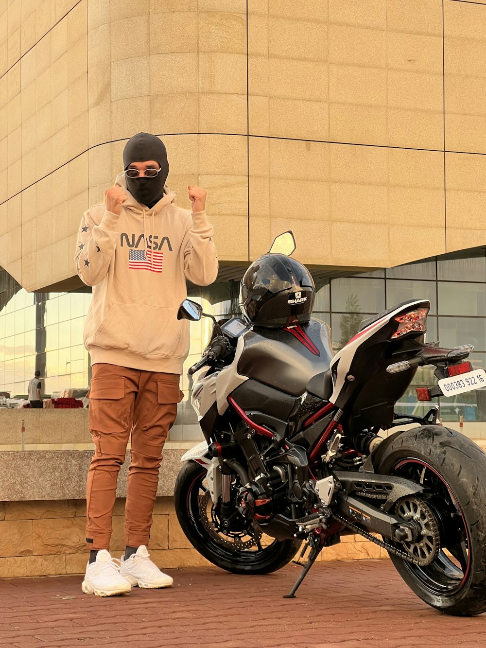 a man standing next to a parked motorcycle