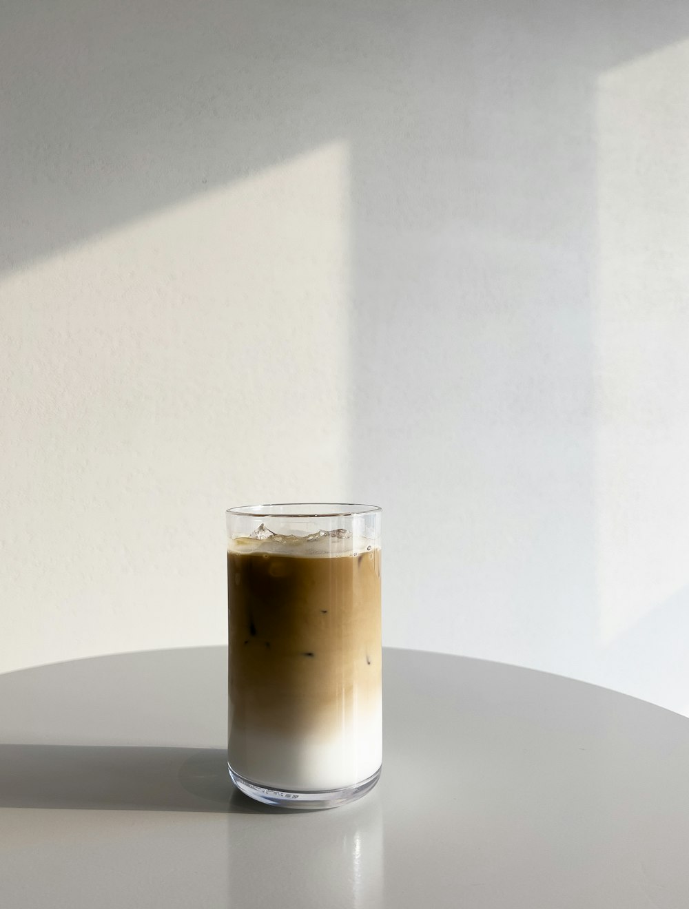 a cup of coffee sitting on top of a white table