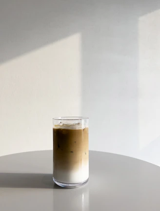 a cup of coffee sitting on top of a white table
