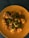A close-up of fresh paneer cubes on a wooden cutting board.
