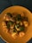 A close-up of fresh paneer cubes on a wooden cutting board.