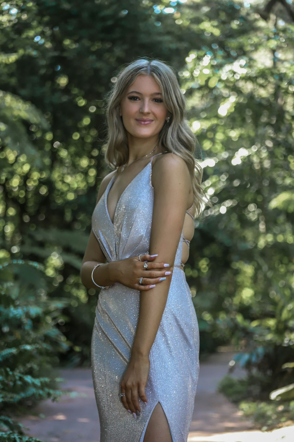 a woman in a silver dress posing for a picture