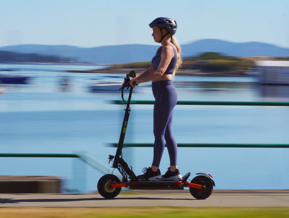 a woman riding a scooter with a helmet on