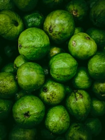 Close-up of a smooth, rich guava paste spread on rustic wooden board.