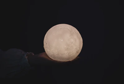 Close-up of a handcrafted mystical relic glowing softly under moonlight.