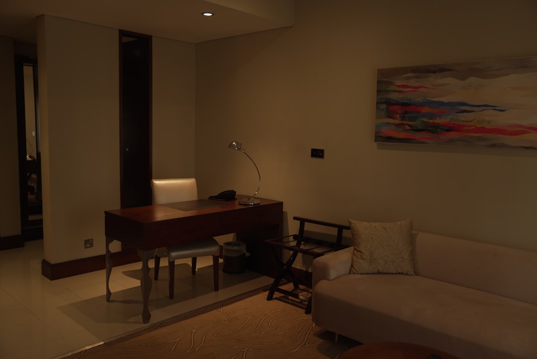a living room with a couch and a desk,