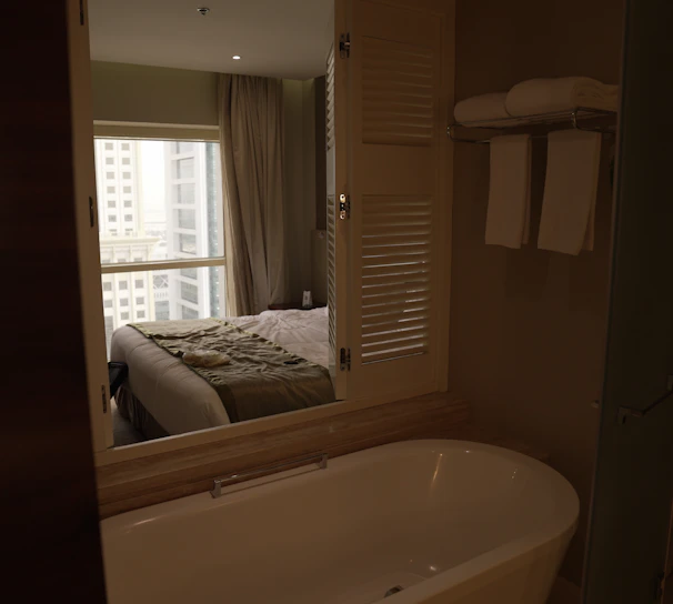 Modern bathroom with sleek fixtures and fresh towels in classic room.