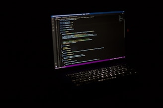 Close-up of laptop screen with code, reflecting the computational aspects of transformer models 
