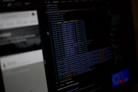 Dark-themed digital wireframe of a website in development with code snippets.