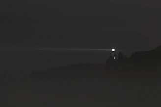 a foggy night with a light in the distance
