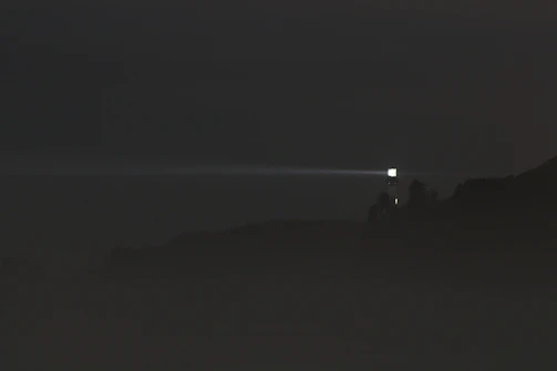 a foggy night with a light in the distance