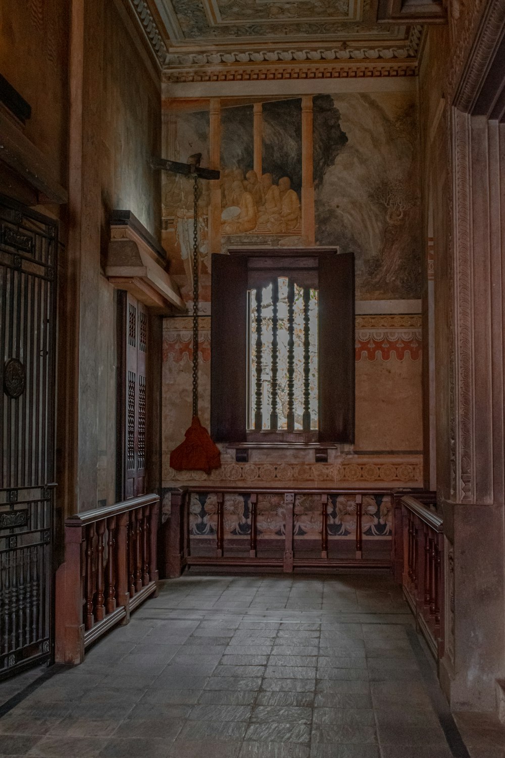 an empty room with a large window and a painting on the wall