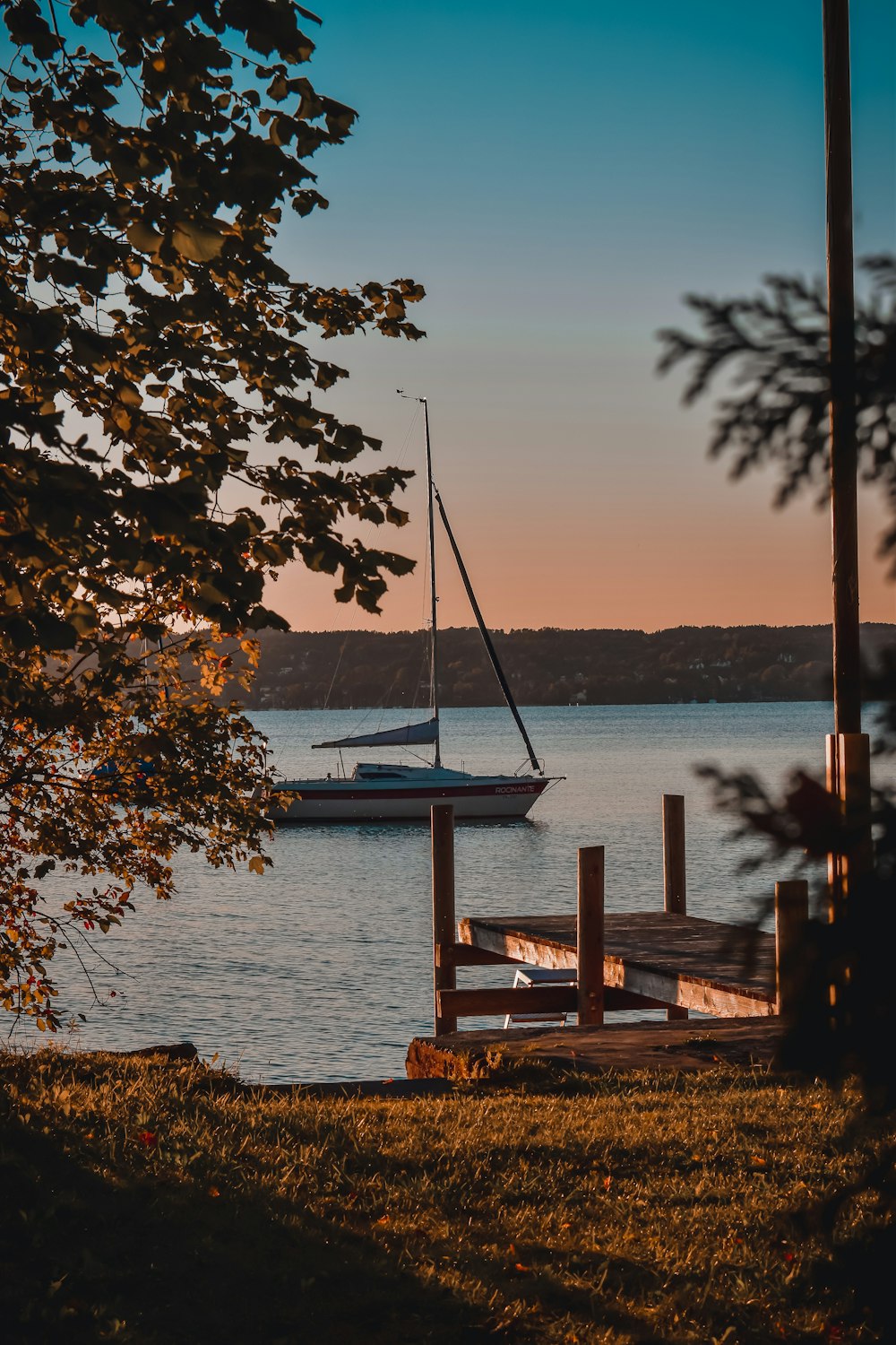 a sailboat is docked at the end of a dock