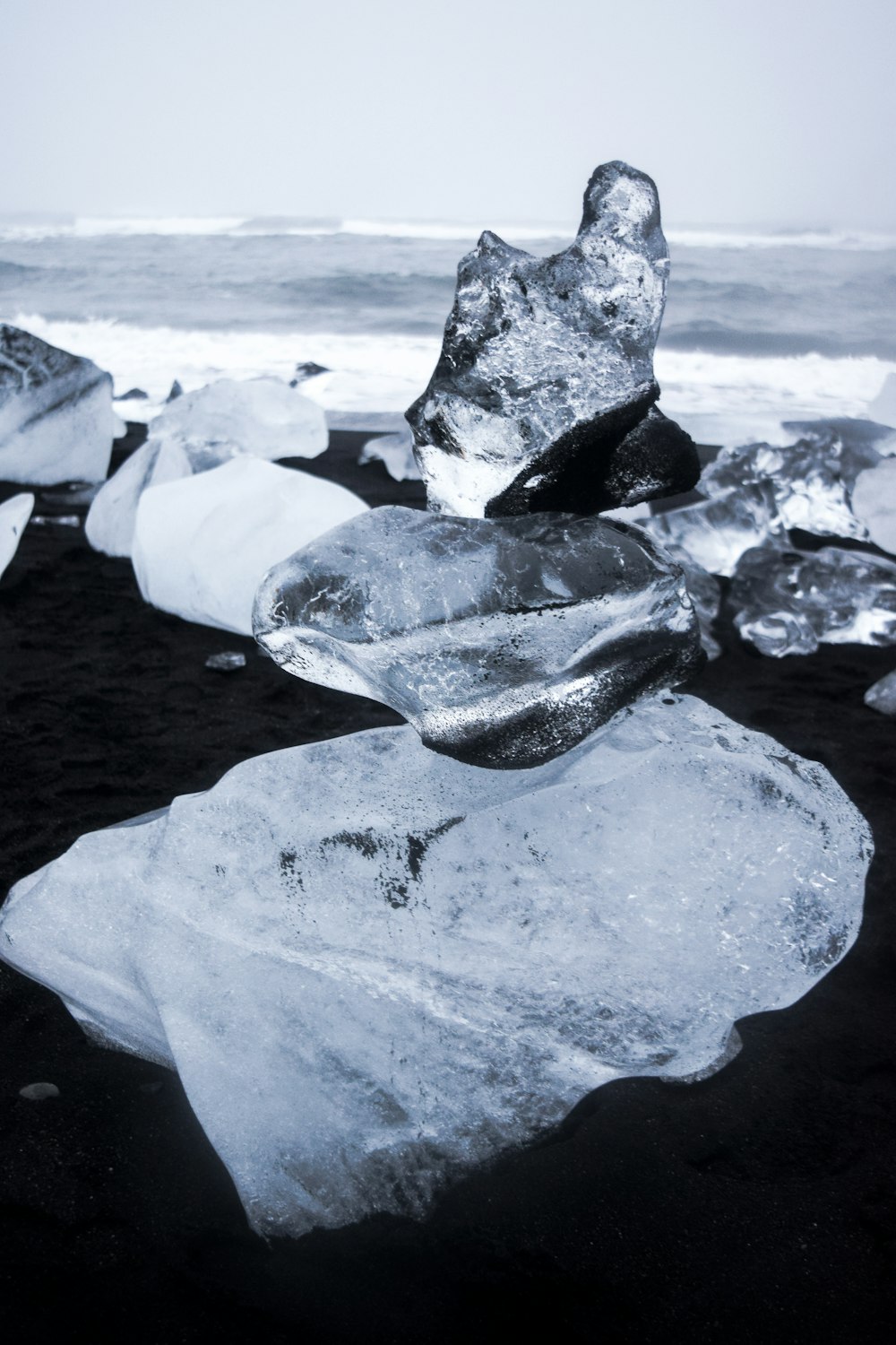 a rock formation made of ice on a beach