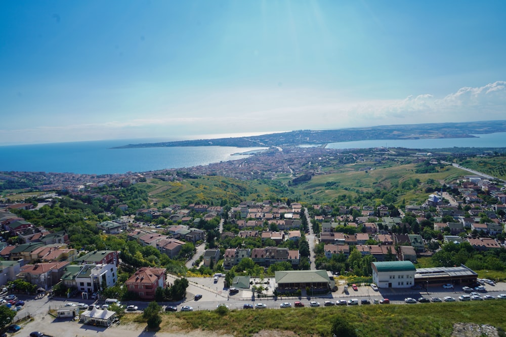 an aerial view of a city with a lake in the background