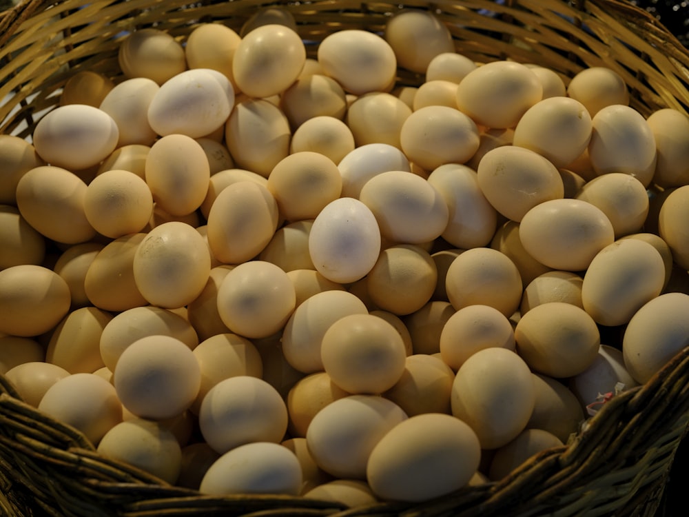 a basket filled with eggs sitting on top of a table