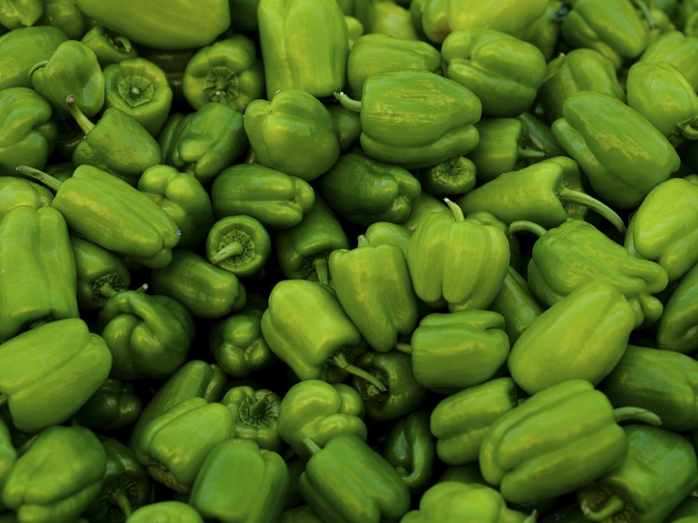 a pile of green peppers sitting next to each other